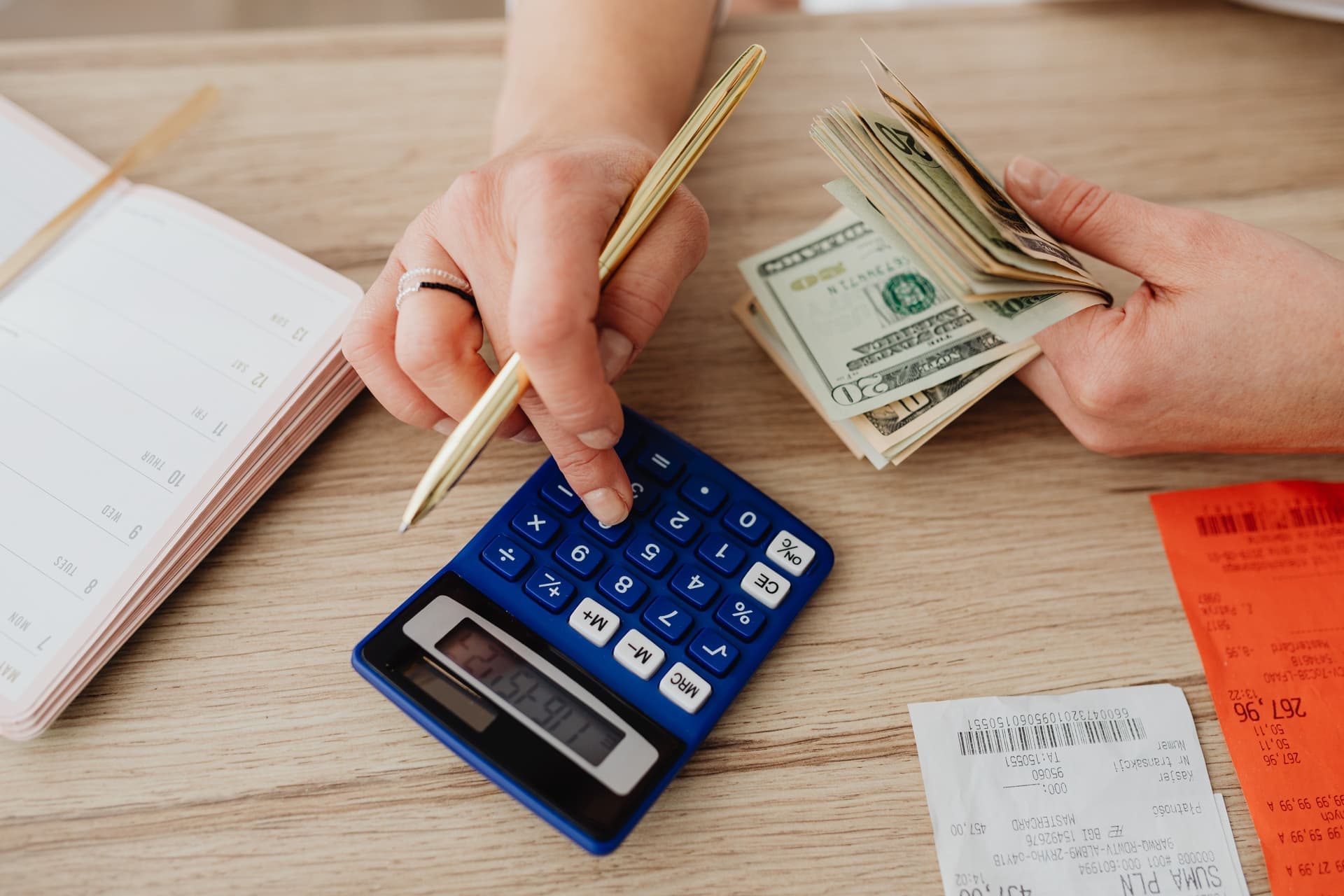 A calculator and notepad on a desk